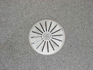 A supply air diffuser on the floor. The text above describes the image.